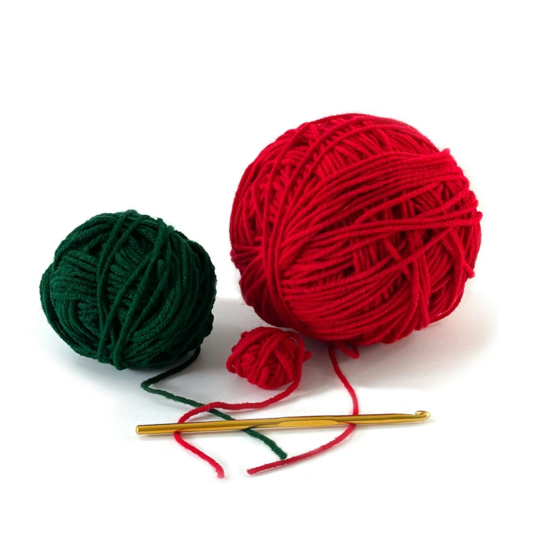 Red and green yarn with crochet hook